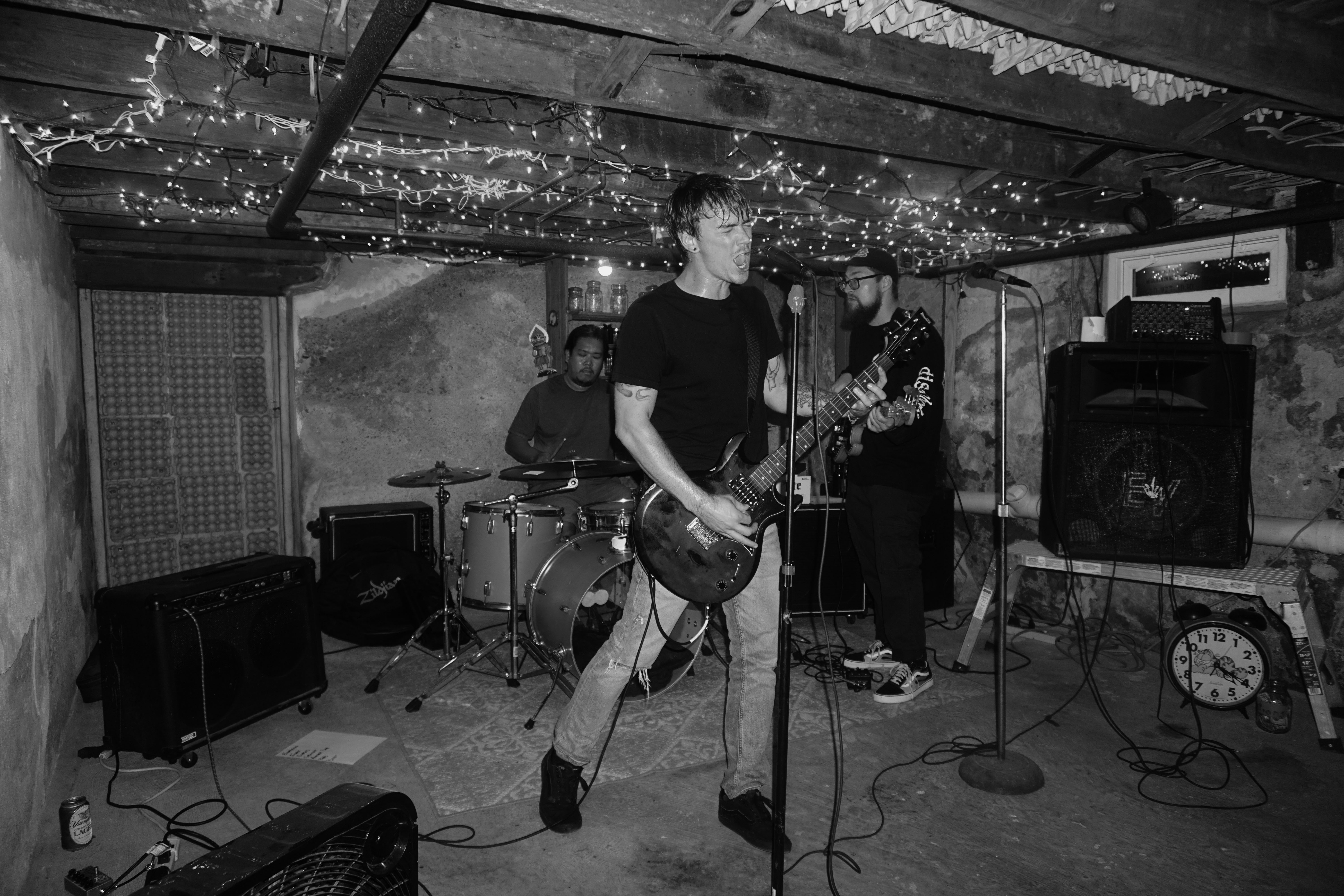 The band Chiseled Lilies playing punk music in a basement